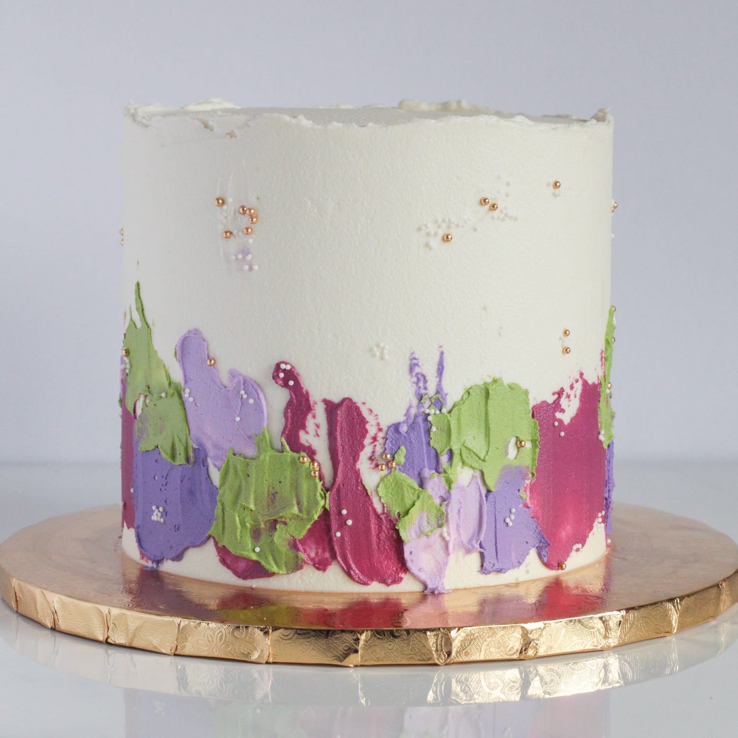White cake with colourful textured buttercream
